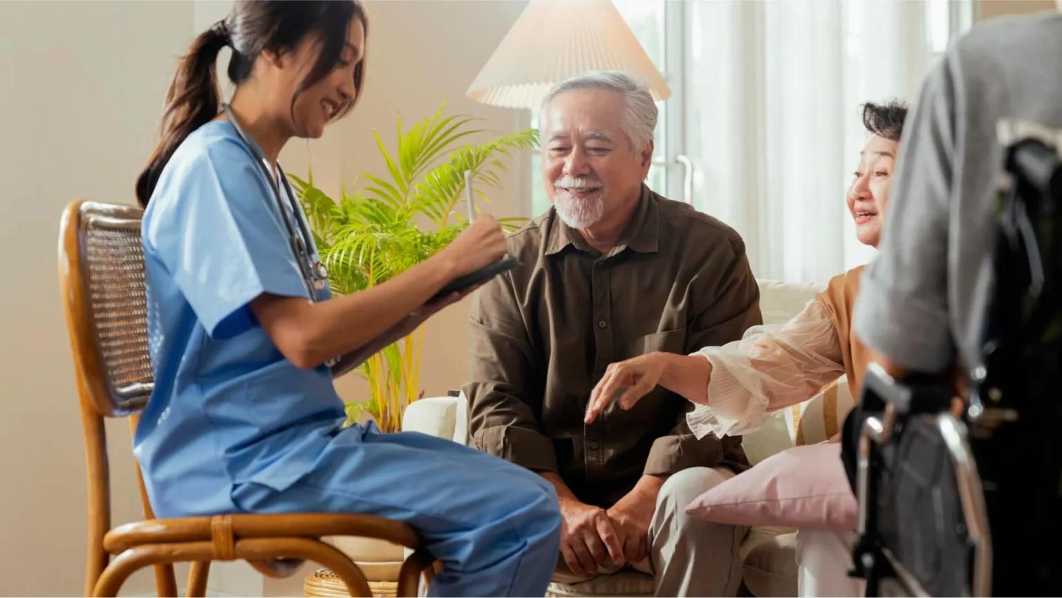 Compassionate caregiver consulting with elderly couple at home