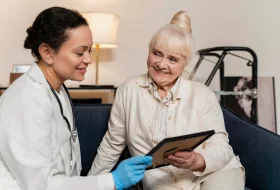 Healthcare provider sharing memories with elderly resident