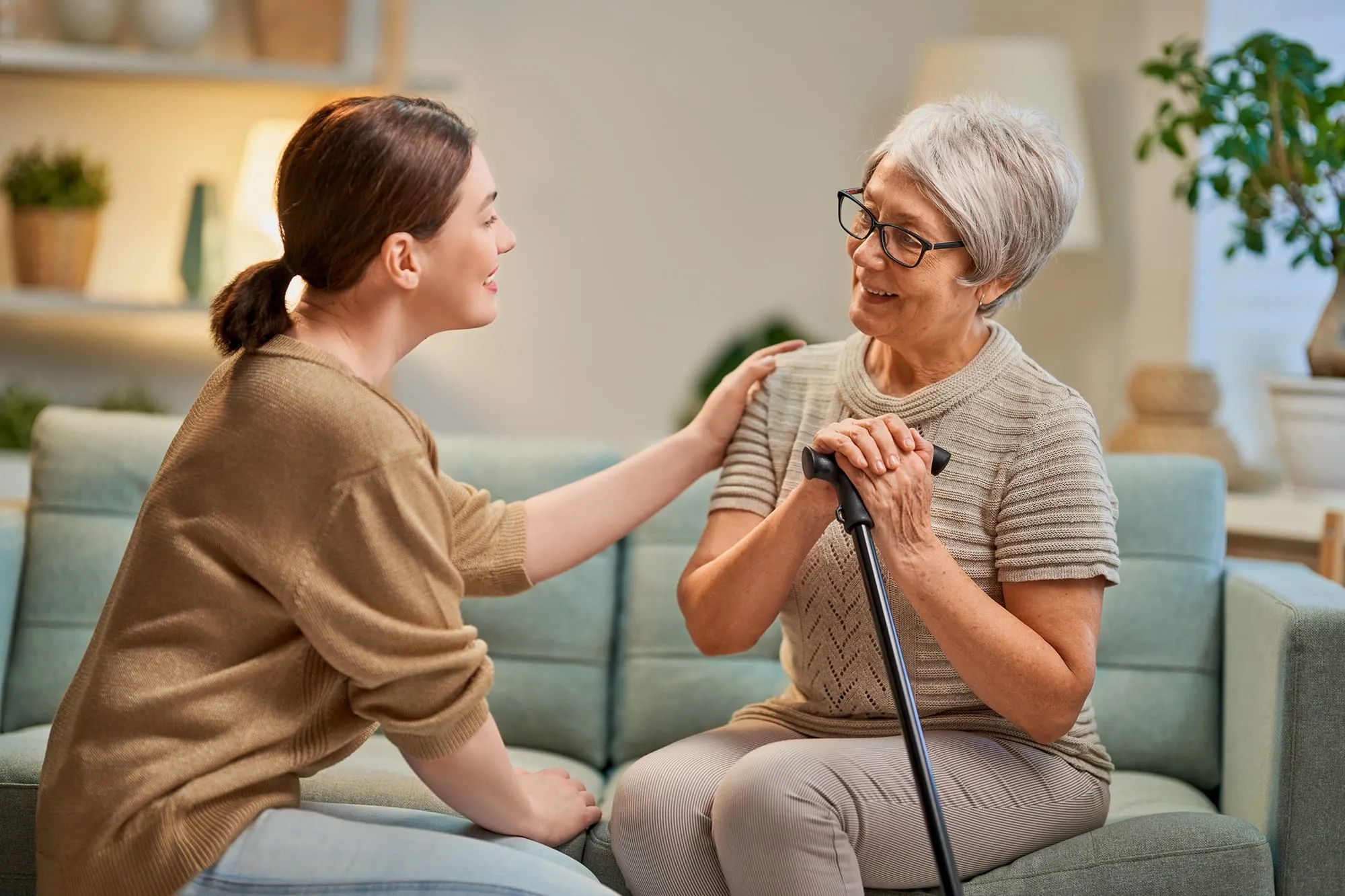 Compassionate respite caregiver assisting an elderly client at home